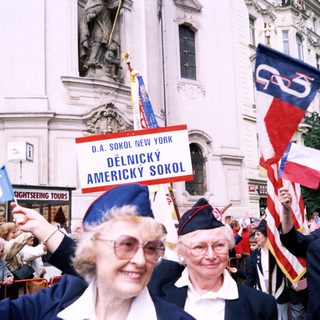 Polish-American cultural parade participants with flags.