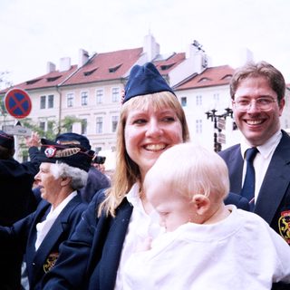 Family posing at outdoor public event.