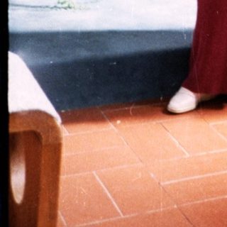 Religious ceremony with woman reading and man holding cup.