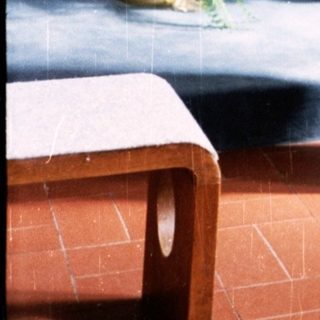 Woman in red standing at church altar.