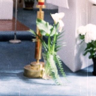 Woman holding prayer book in modern church.