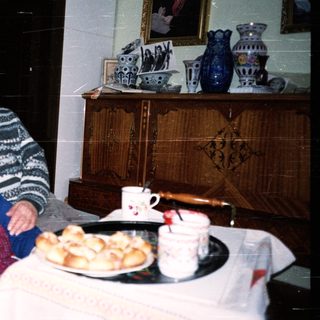 Elderly couple enjoying pastries indoors together.