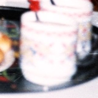Elderly couple enjoying pastries indoors together.