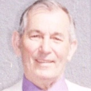 Man in white coat standing in church.