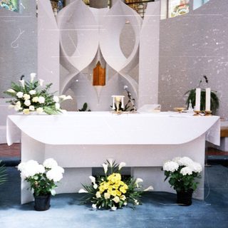 Elegant altar with floral arrangements and candles.