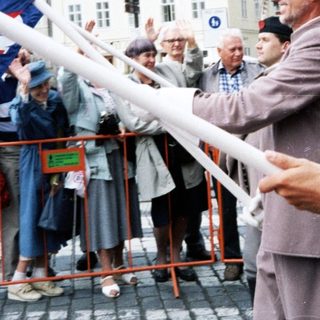 People holding Czech flag in public celebration.