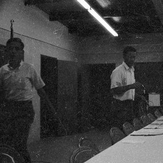 Classroom lecture with teacher and seated students.