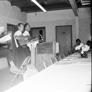 Meeting or conference with speakers addressing audience.