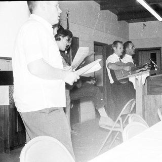 Meeting or conference with speakers addressing audience.