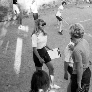 Children playing soccer on outdoor field.