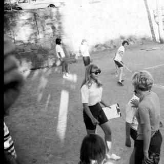 Children playing soccer on outdoor field.