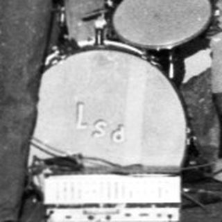 Band performing live with young boy watching.
