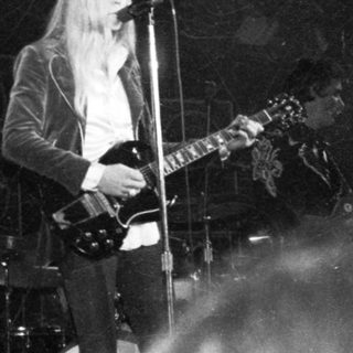 Rock musician performing live on stage.