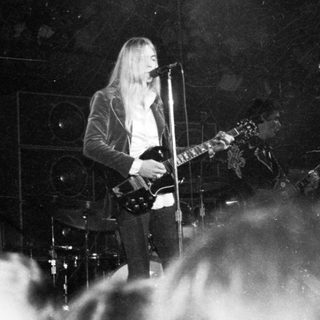 Rock musician performing live on stage.