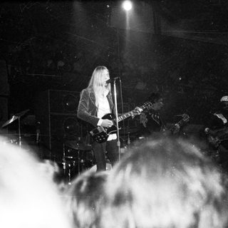 Rock musician performing live on stage.