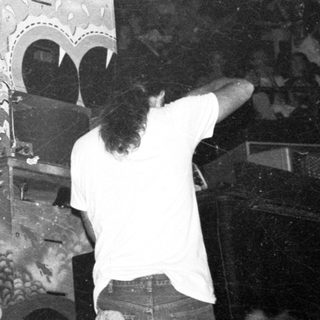 Live band performing in dimly lit venue.