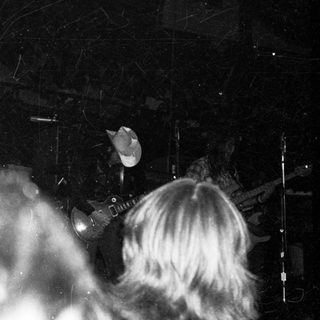 Live band performing on stage at night.