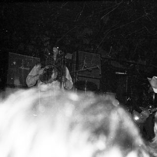 Live band performing on stage at night.