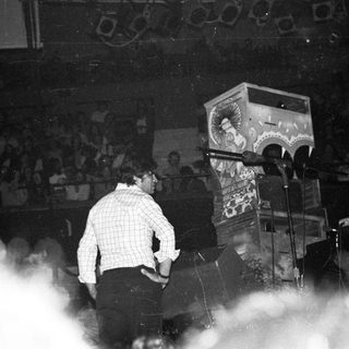 DJ performing at indoor live music event.