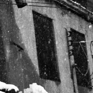 Person clearing snow from rooftop.