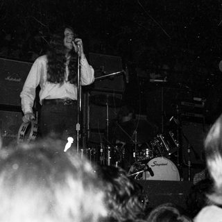 Live band performing on stage with singer.