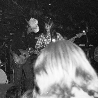 Live band performing with guitarist and drummer.