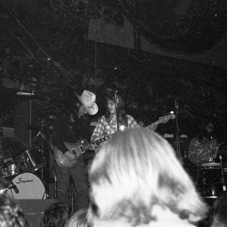 Live band performing with guitarist and drummer.