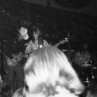 Live band performing with guitarist and drummer.
