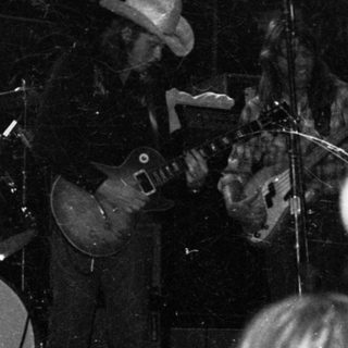 Live band performing on stage with audience.