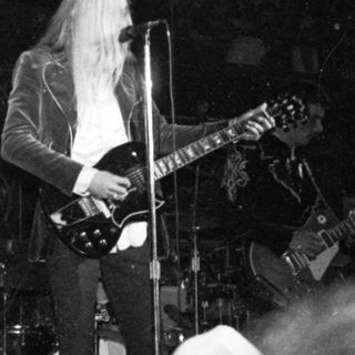 Guitarist performing live on stage.