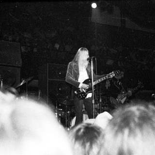 Guitarist performing live on stage.