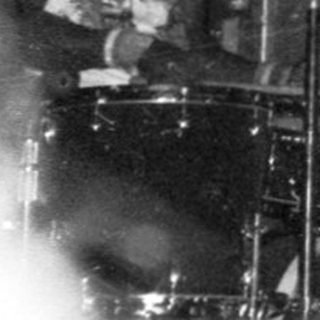 Live band performing on stage with audience.