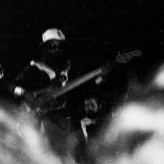 Band performing live on stage with smoke.