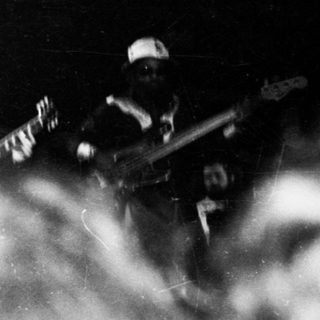 Band performing live on stage with smoke.