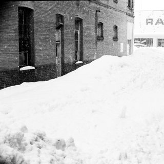 Snow-covered street and buildings in winter.