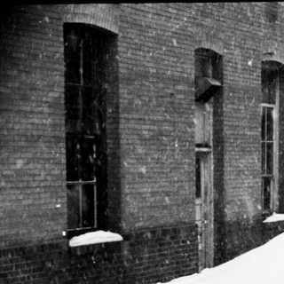 Snow-covered street and buildings in winter.
