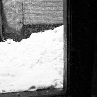 Snow piled against a building exterior.