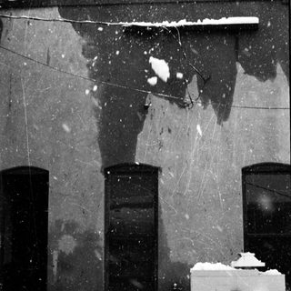 Snow-covered exterior of an old building.