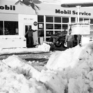 Snow clearing at Mobil gas station service area.