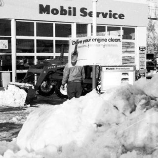 Snow clearing at Mobil gas station service area.