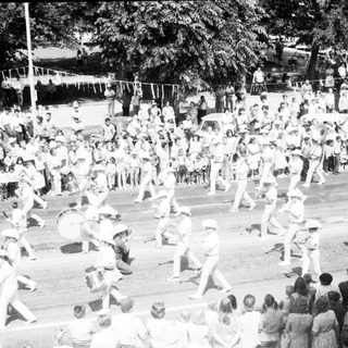 Large crowd participating in outdoor group dance.