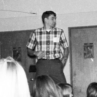 Classroom lecture with teacher addressing students.