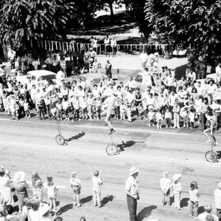 Unicycle performance in front of large crowd.