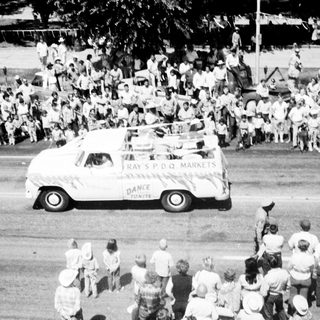 Vintage parade truck with crowd watching.