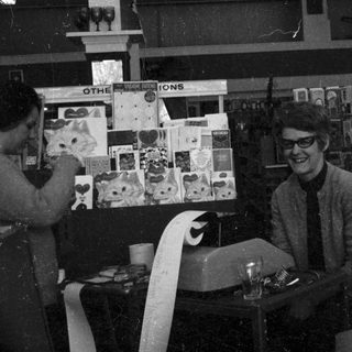 Vintage record store owner behind counter.