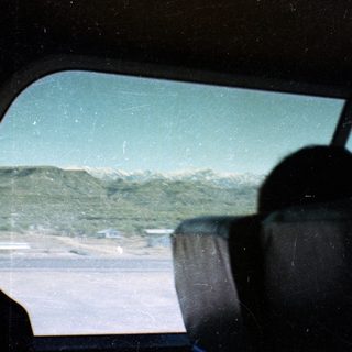 View from inside a vehicle on a snowy mountain road.