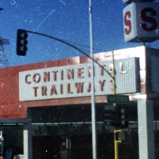 "Vintage Continental Trailway bus station in city."