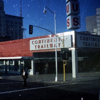 "Vintage Continental Trailway bus station in city."