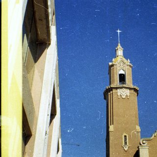 Historic church with bell tower and cross.