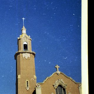 Historic church with bell tower and cross.
